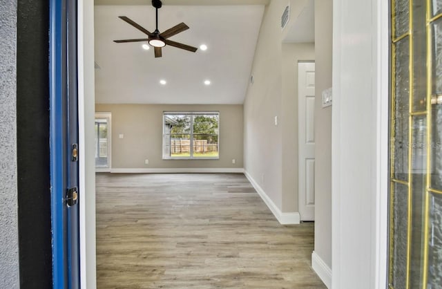 foyer entrance with light wood-type flooring, ceiling fan, and vaulted ceiling