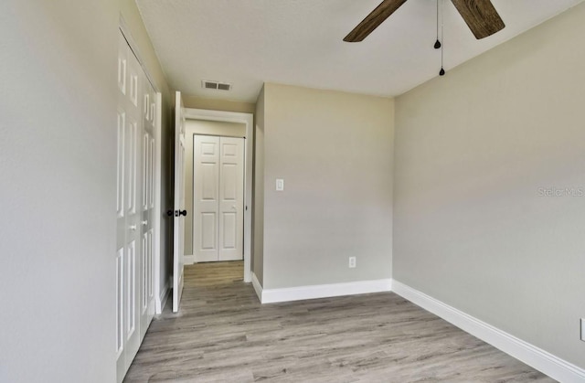 empty room featuring ceiling fan and light wood-type flooring