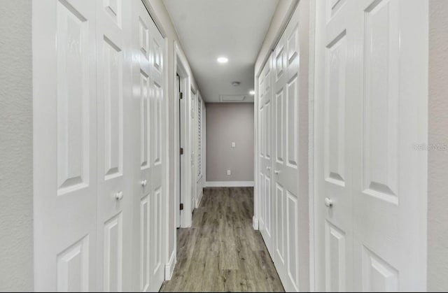 corridor with light hardwood / wood-style floors