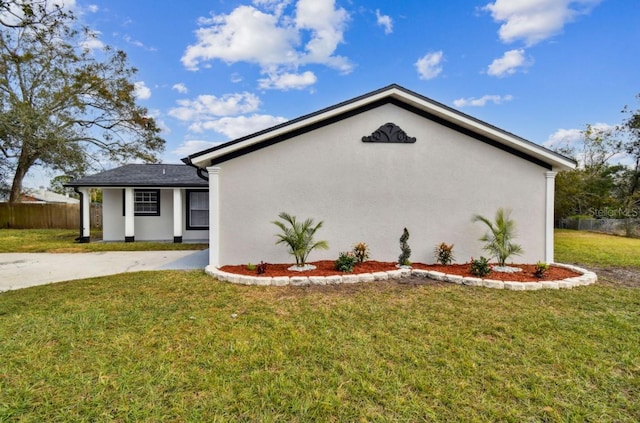 view of side of property with a lawn