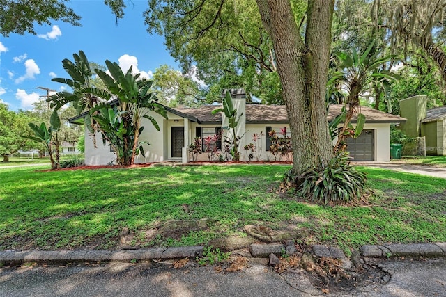 single story home with a garage and a front lawn