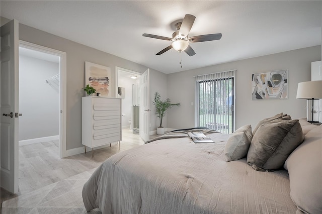 bedroom featuring ceiling fan and a walk in closet