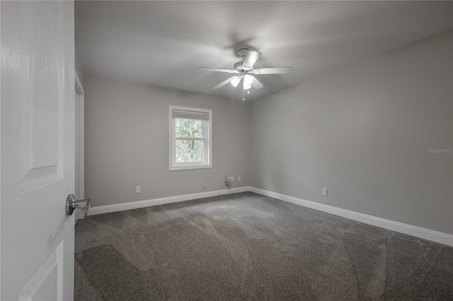 empty room with dark colored carpet and ceiling fan