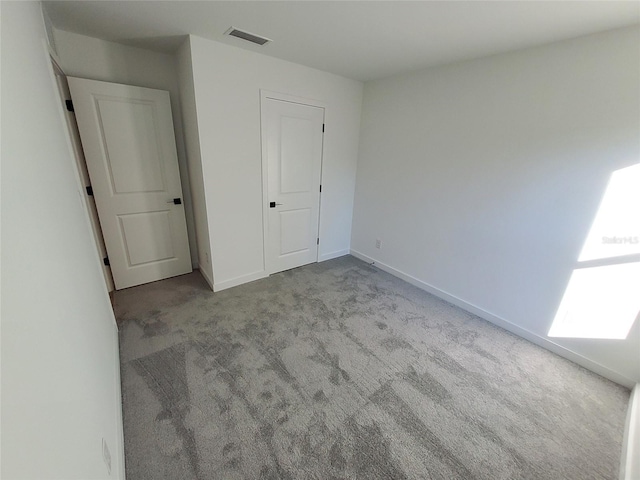 unfurnished bedroom featuring light carpet