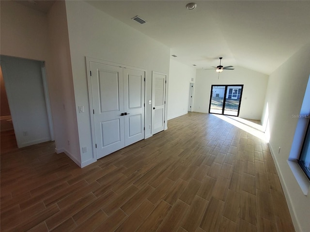 unfurnished living room featuring ceiling fan and vaulted ceiling