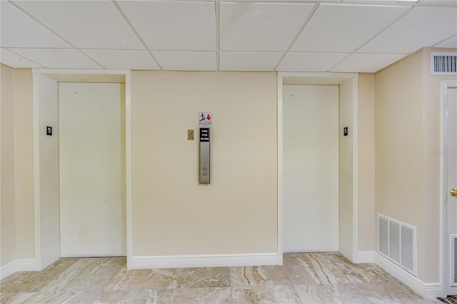 interior space featuring elevator and a drop ceiling