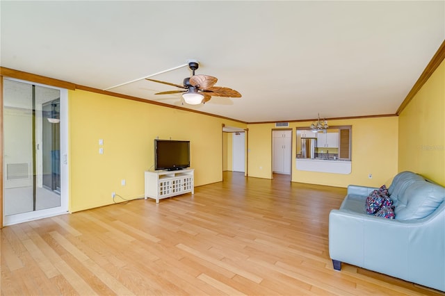 unfurnished living room featuring crown molding, hardwood / wood-style flooring, and ceiling fan with notable chandelier