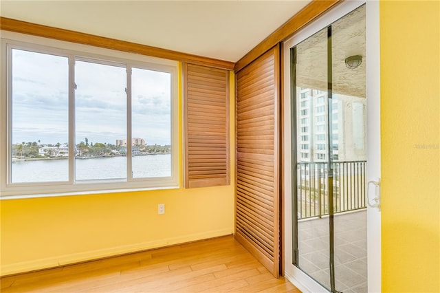 unfurnished sunroom with a water view