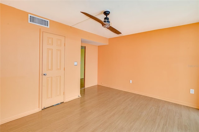 empty room with ceiling fan and light hardwood / wood-style floors