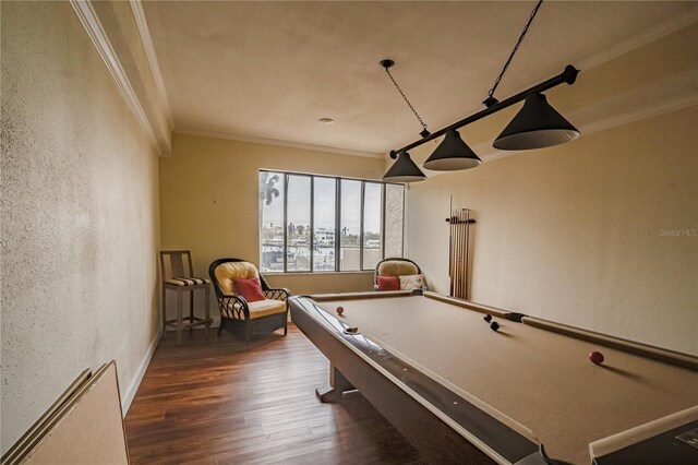 game room featuring ornamental molding, dark wood-type flooring, and pool table