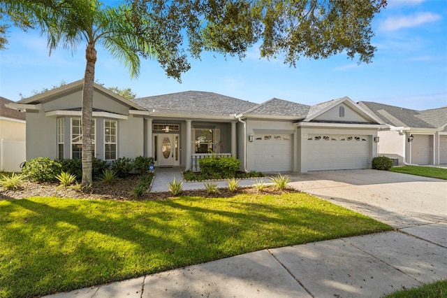 ranch-style house featuring a garage and a front lawn