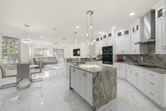 kitchen with backsplash, kitchen peninsula, wall chimney exhaust hood, and pendant lighting