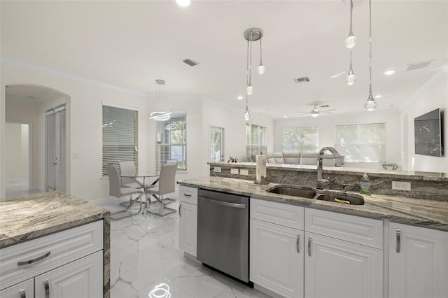 kitchen with dishwasher, white cabinets, hanging light fixtures, and sink