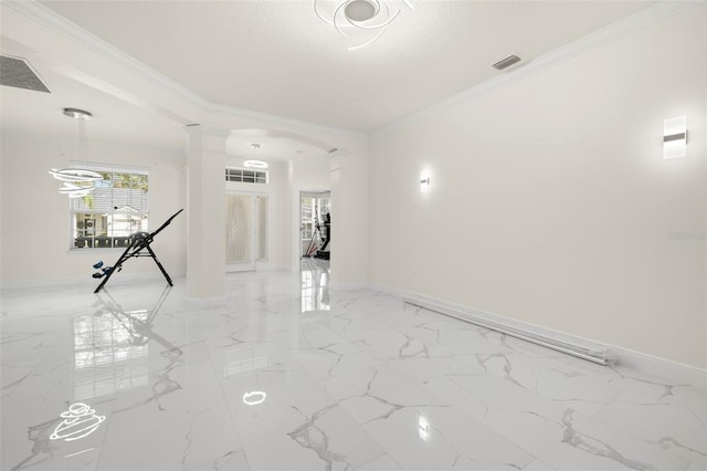 spare room with a textured ceiling, ornamental molding, and decorative columns