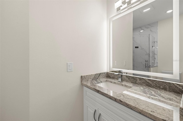 bathroom featuring an enclosed shower and vanity