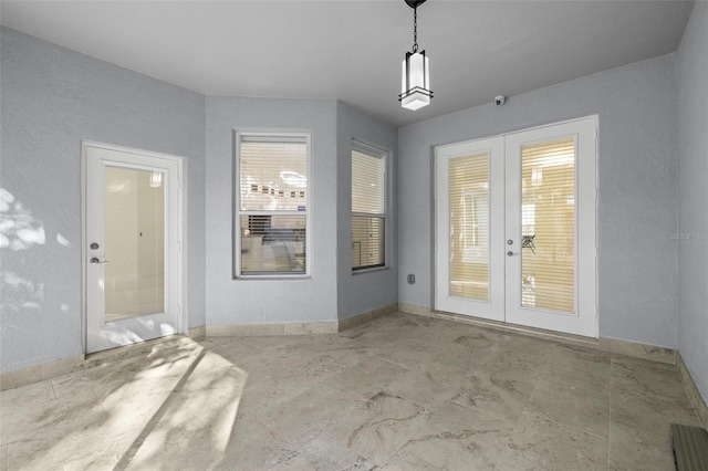 doorway to outside featuring a wealth of natural light and french doors