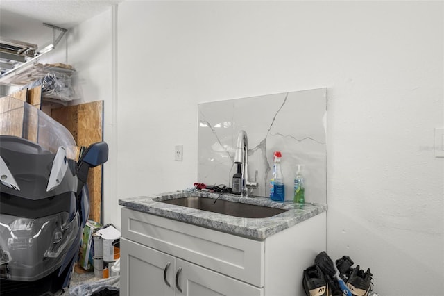 bar with sink and light stone counters