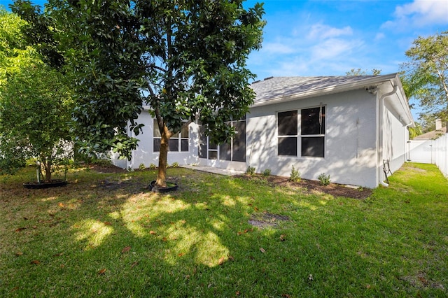 back of house featuring a yard