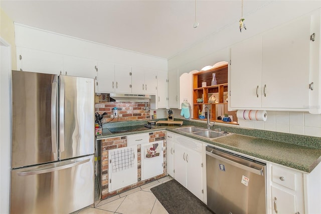 kitchen featuring appliances with stainless steel finishes, white cabinetry, sink, decorative backsplash, and light tile patterned floors