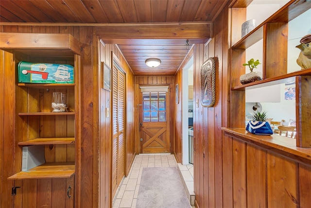 hallway featuring wood ceiling and wooden walls