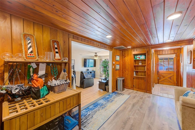 interior space with wood ceiling, wood walls, and hardwood / wood-style flooring