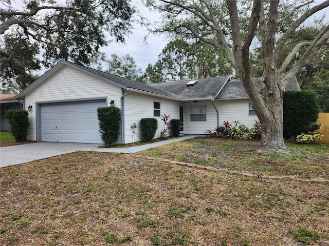 single story home with a garage and a front yard