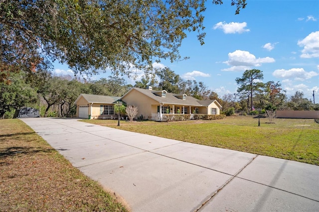 ranch-style house featuring a garage, a front lawn, and a porch