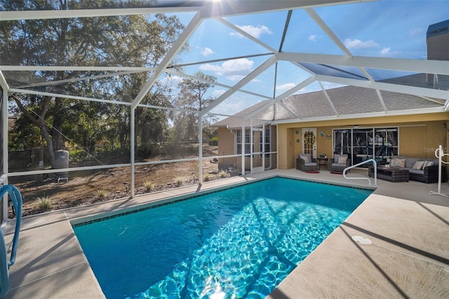 view of pool with a lanai, ceiling fan, a patio area, and outdoor lounge area