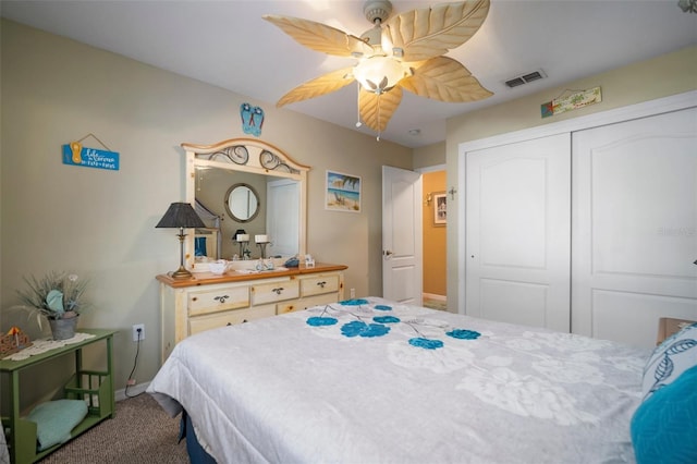 carpeted bedroom with ceiling fan and a closet