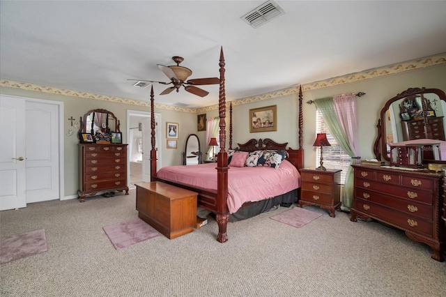 carpeted bedroom with ceiling fan and ensuite bath