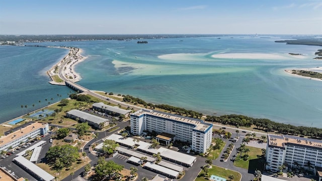 drone / aerial view with a water view and a beach view