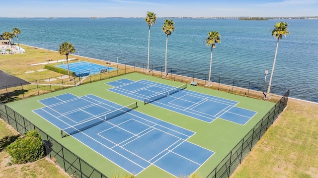 view of sport court with a water view