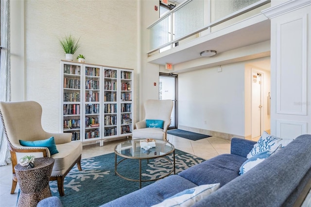 tiled living room featuring a high ceiling