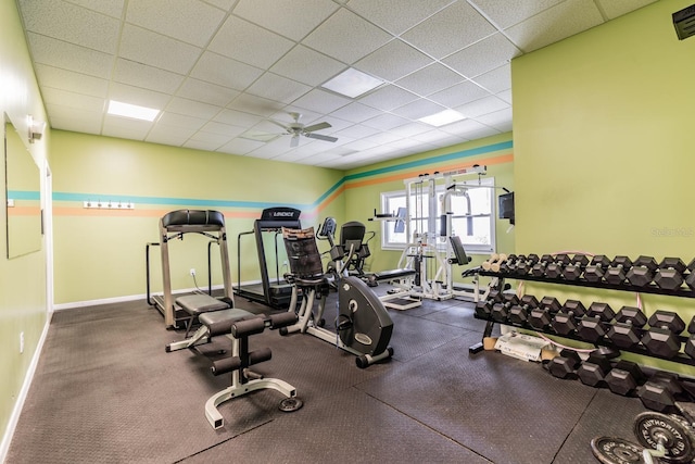 workout area with ceiling fan and a drop ceiling