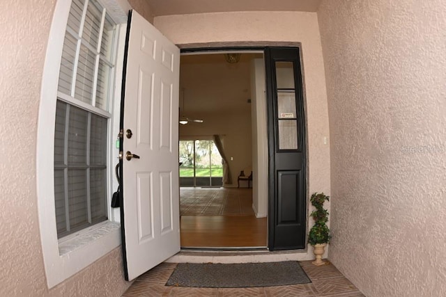 entrance to property with stucco siding