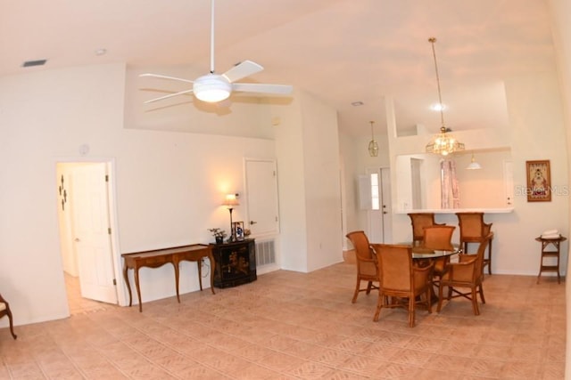 dining area with high vaulted ceiling, ceiling fan, and visible vents