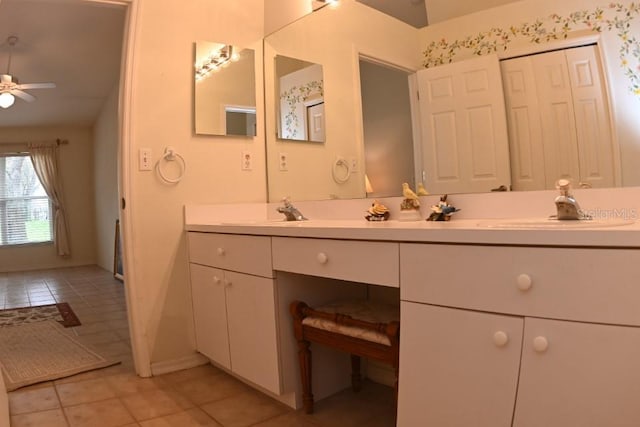 bathroom with ceiling fan, double vanity, a sink, and tile patterned floors