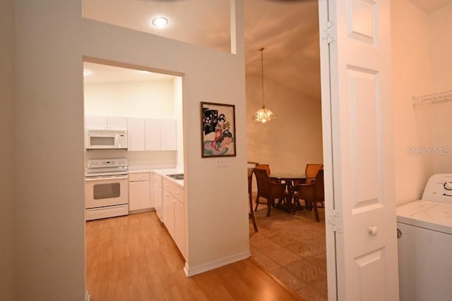 hallway featuring light wood finished floors and washer / clothes dryer