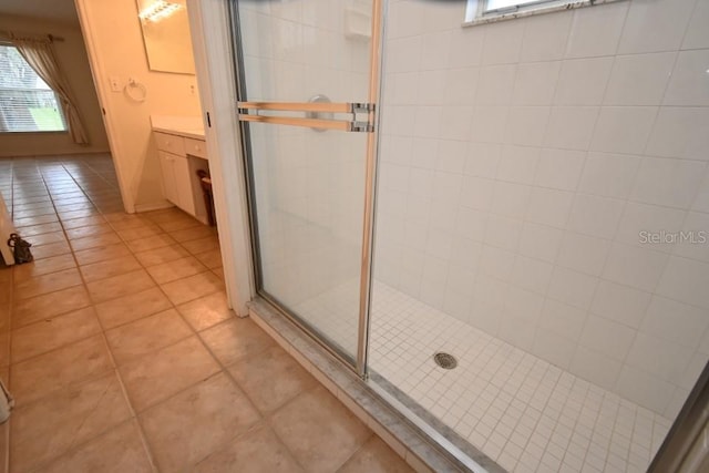 bathroom featuring a stall shower, vanity, and tile patterned floors