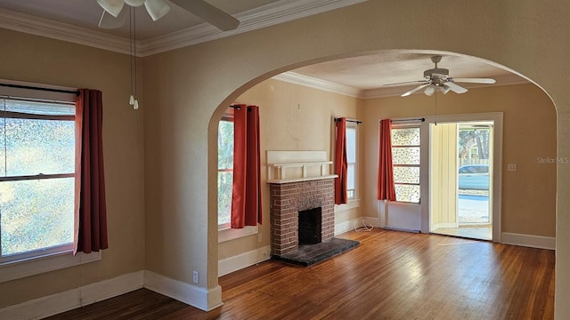 unfurnished living room with ceiling fan, ornamental molding, hardwood / wood-style floors, and a wealth of natural light