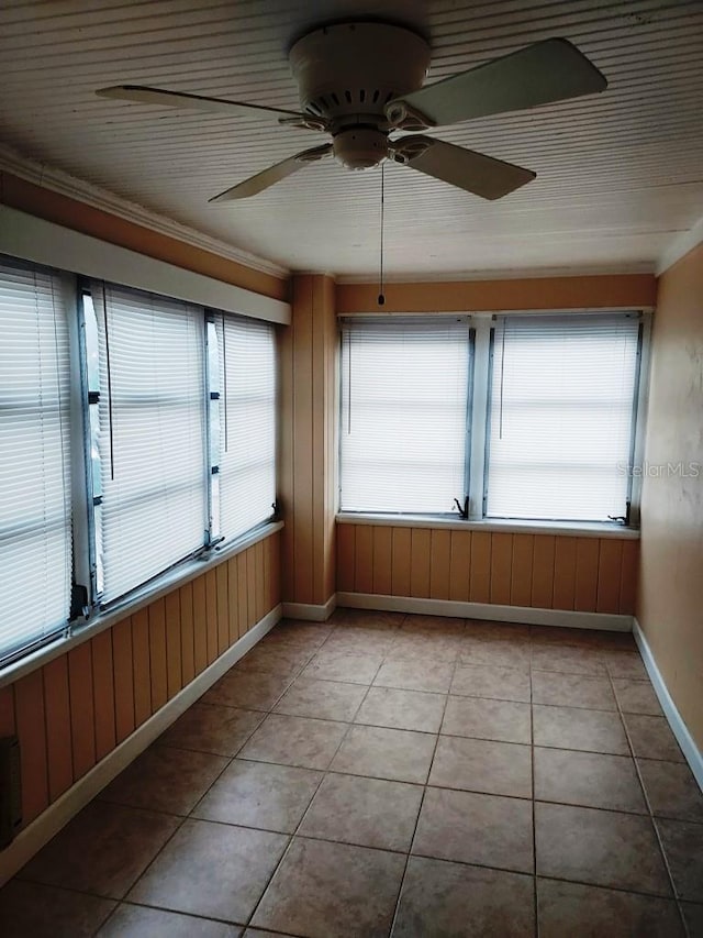 unfurnished sunroom featuring ceiling fan