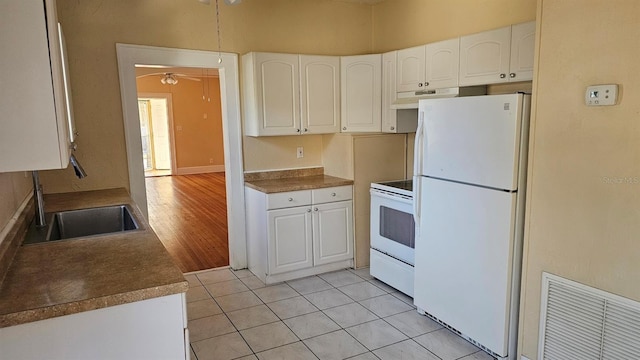 kitchen featuring light tile patterned flooring, white cabinetry, sink, ceiling fan, and white appliances