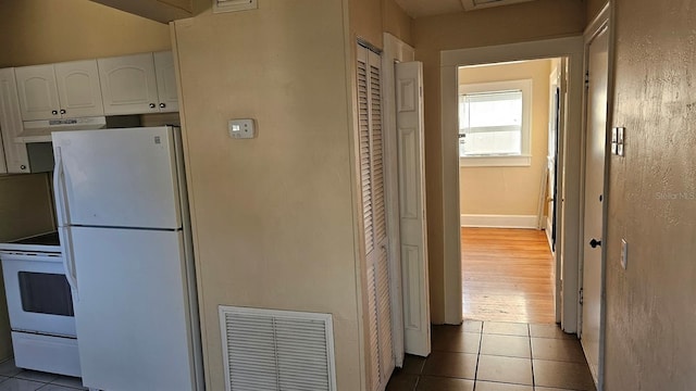 hallway with light tile patterned floors