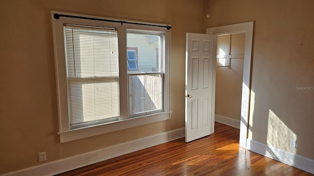 spare room with wood-type flooring