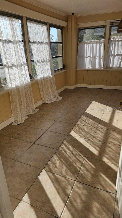 unfurnished sunroom with plenty of natural light