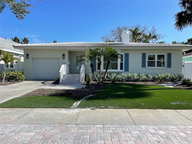 ranch-style home featuring a front yard and a garage