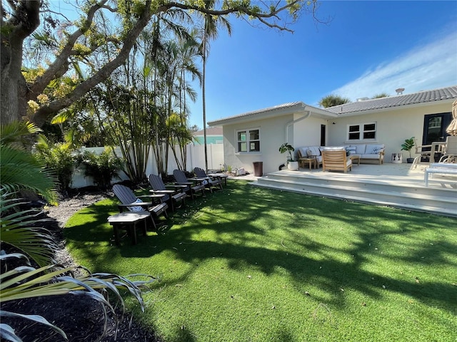 rear view of property with a lawn and an outdoor hangout area