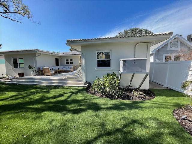 back of house featuring an outdoor hangout area and a lawn