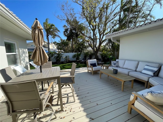 wooden terrace with an outdoor living space