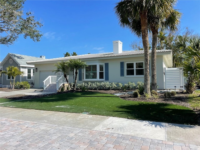 ranch-style home with a front lawn